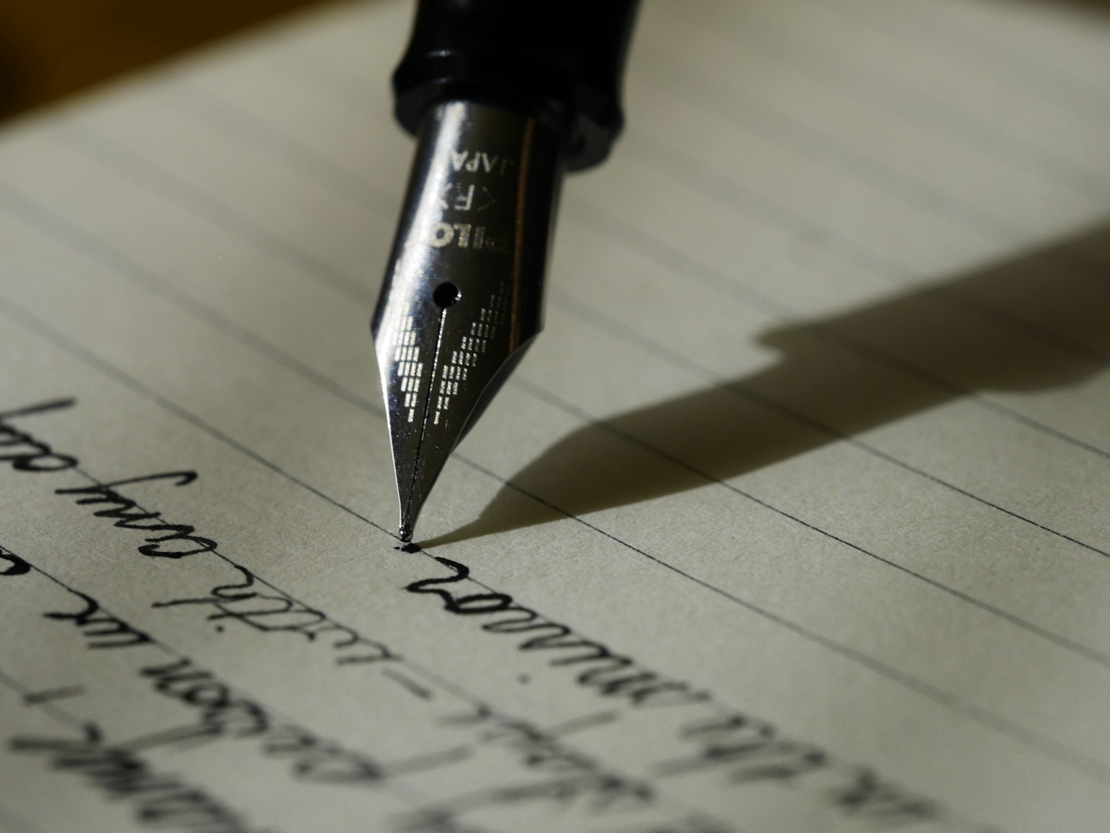 Handwritten note scribbled on a paper napkin beside a coffee cup